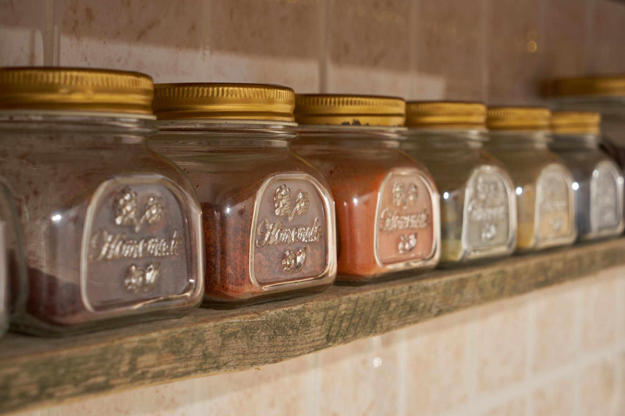Small-batch preserves and herbs on shelf